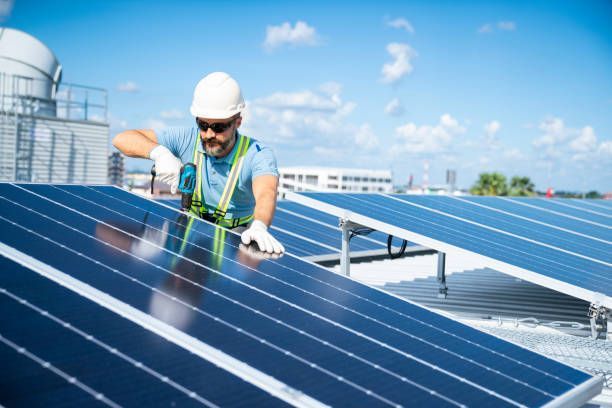Technician cleaning residential solar panels