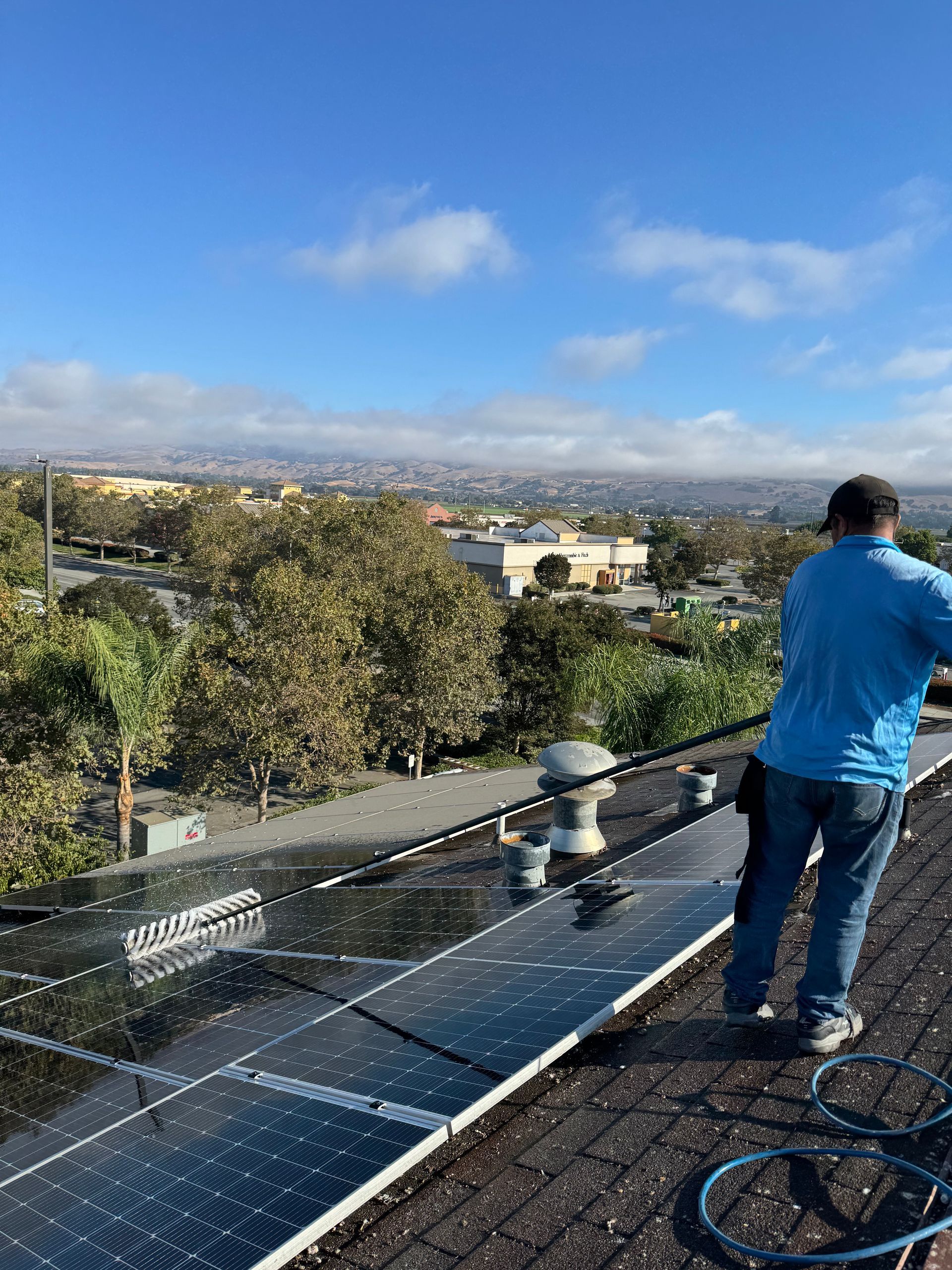 A real All One Solar Shine job: technician cleaning residential rooftop solar panels